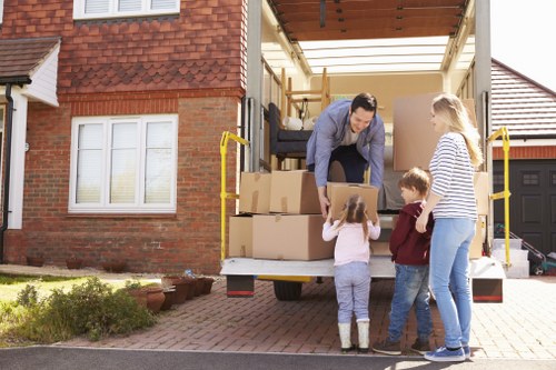 Moving boxes and furniture ready for flat removals in Harmondsworth