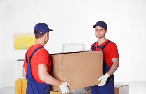 Person arranging stored boxes in a clean and organized Harmondsworth storage space